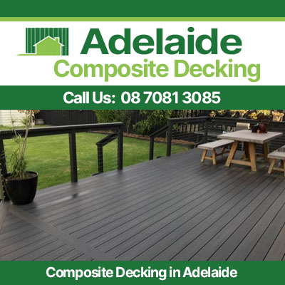 Modern composite deck installation in Adelaide featuring dark grey planks and wooden furniture